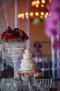 Elegant wedding cake and floral centerpiece with crystal decor.