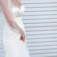 Bride in elegant white wedding dress with veil.