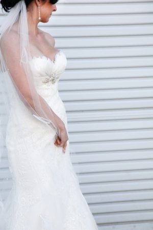 Bride in elegant white wedding dress with veil.