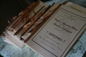 Elegant wedding invitations tied with brown ribbons.