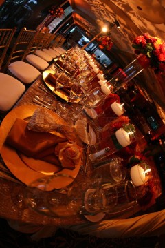 A table set with glasses of beer and plates of food.