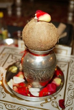 Traditional silver kalash with coconut and red thread on top.
