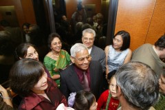 A joyful family gathering with multiple generations sharing smiles and warmth.