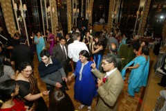 People enjoying a lively dance party in formal attire.