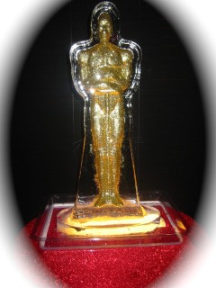 Golden trophy shaped like a human figure on a red base.