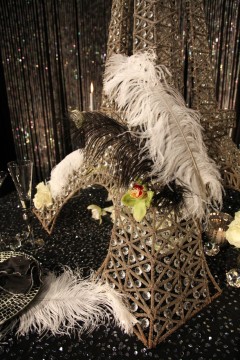 Decorative bird sculpture adorned with feathers and beads.