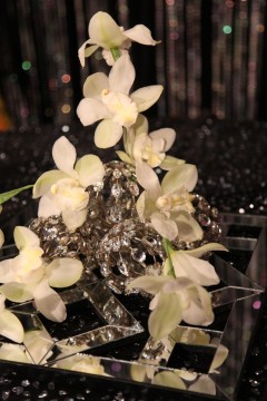 A sparkling star decoration adorned with delicate white flowers.