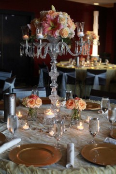 Elegant dining table with crystal centerpiece and roses.