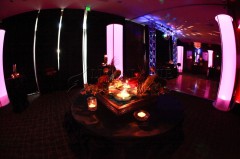Dimly lit event space with candles and ambient lighting.
