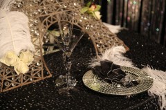 Elegant table setting with a decorative Eiffel Tower and intricate glassware.