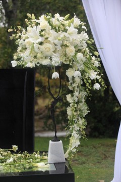 Elegant white floral arrangement cascading from a decorative stand.
