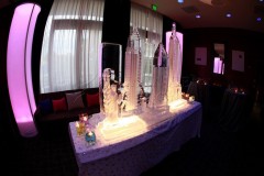 Elegant ice sculptures of New York skyscrapers on a decorated table.