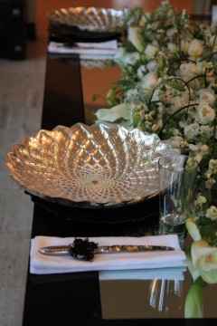 Elegant silver bowl with intricate patterns on a table.