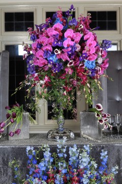 Elegant floral arrangement with vibrant purple and pink flowers in a glass vase.
