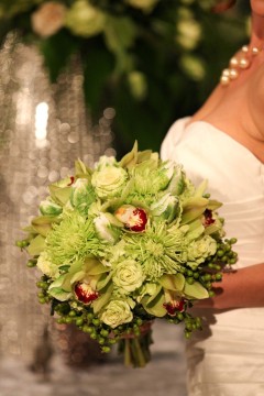Bride holding a lush green and white floral bouquet.