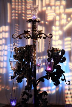 Decorative hanging glass cups illuminated by warm lights.