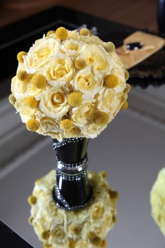 Elegant bouquet of cream-colored roses on a reflective surface.