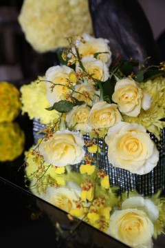 A bouquet of yellow roses and other yellow flowers.
