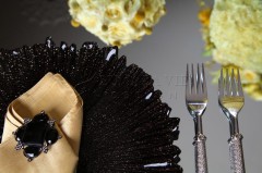 Elegant table setting with black plate and silver fork.
