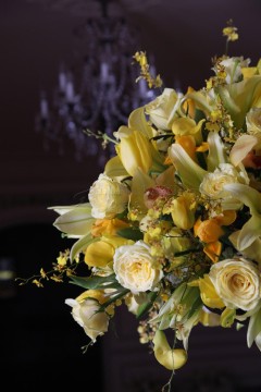 Elegant bouquet of yellow and white flowers in soft lighting.