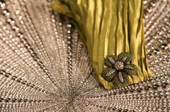 Decorative fabric with a floral embellishment and textured details.