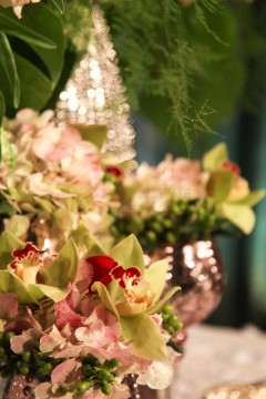Close-up of elegant floral arrangement with orchids and soft greenery.