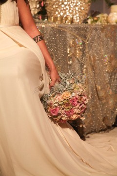 Bride in elegant white gown holding a bouquet of flowers.