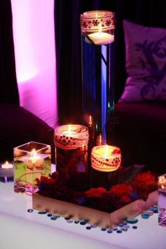 Lit candles creating a cozy ambiance in a dimly lit room.
