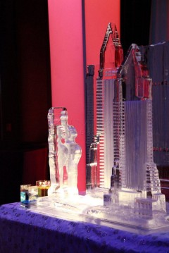 Intricate ice sculptures illuminated by red and blue lighting.