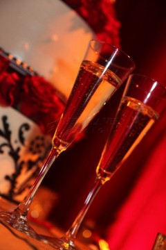Two elegant champagne flutes filled with sparkling wine on a festive background.